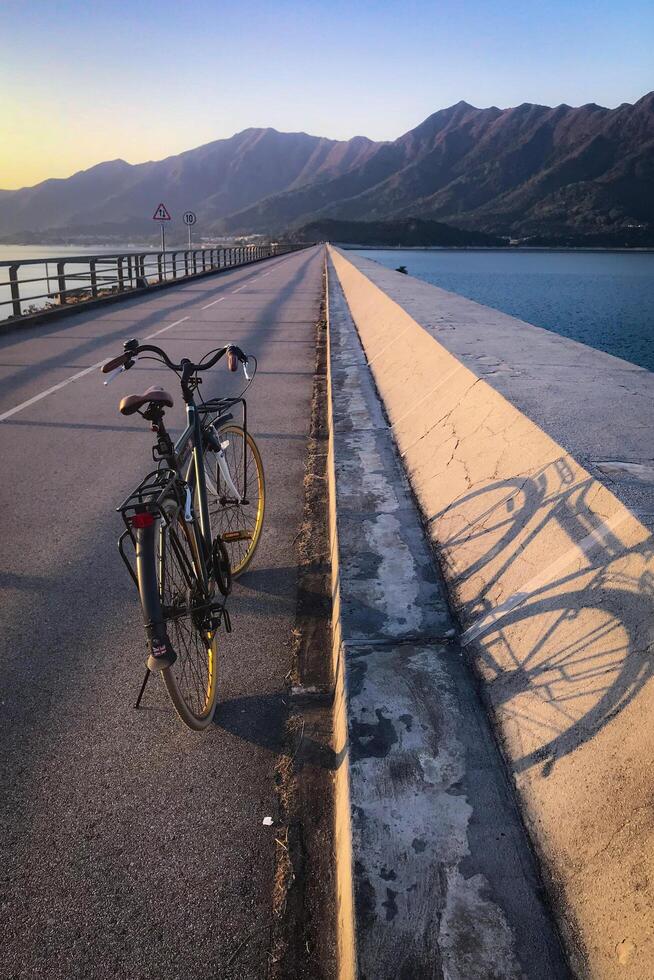 Vertical natural bicycle path, railing with shadow in outdoor park photo