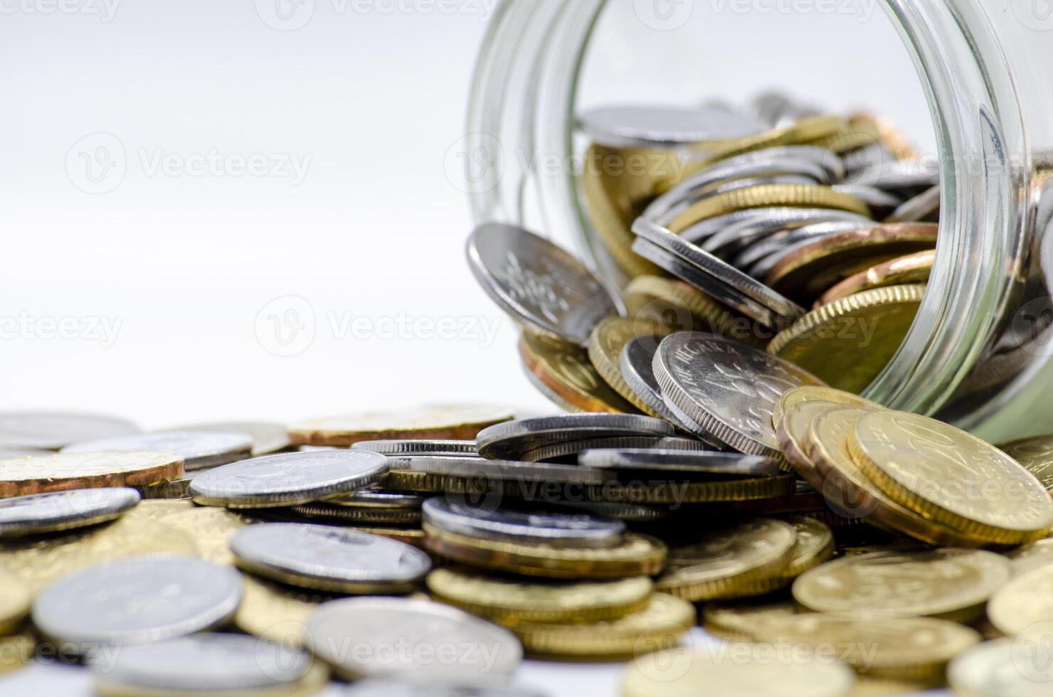 Gold coins in a jar with white background representing business, investment or any monetary concept. Customizable space for text photo