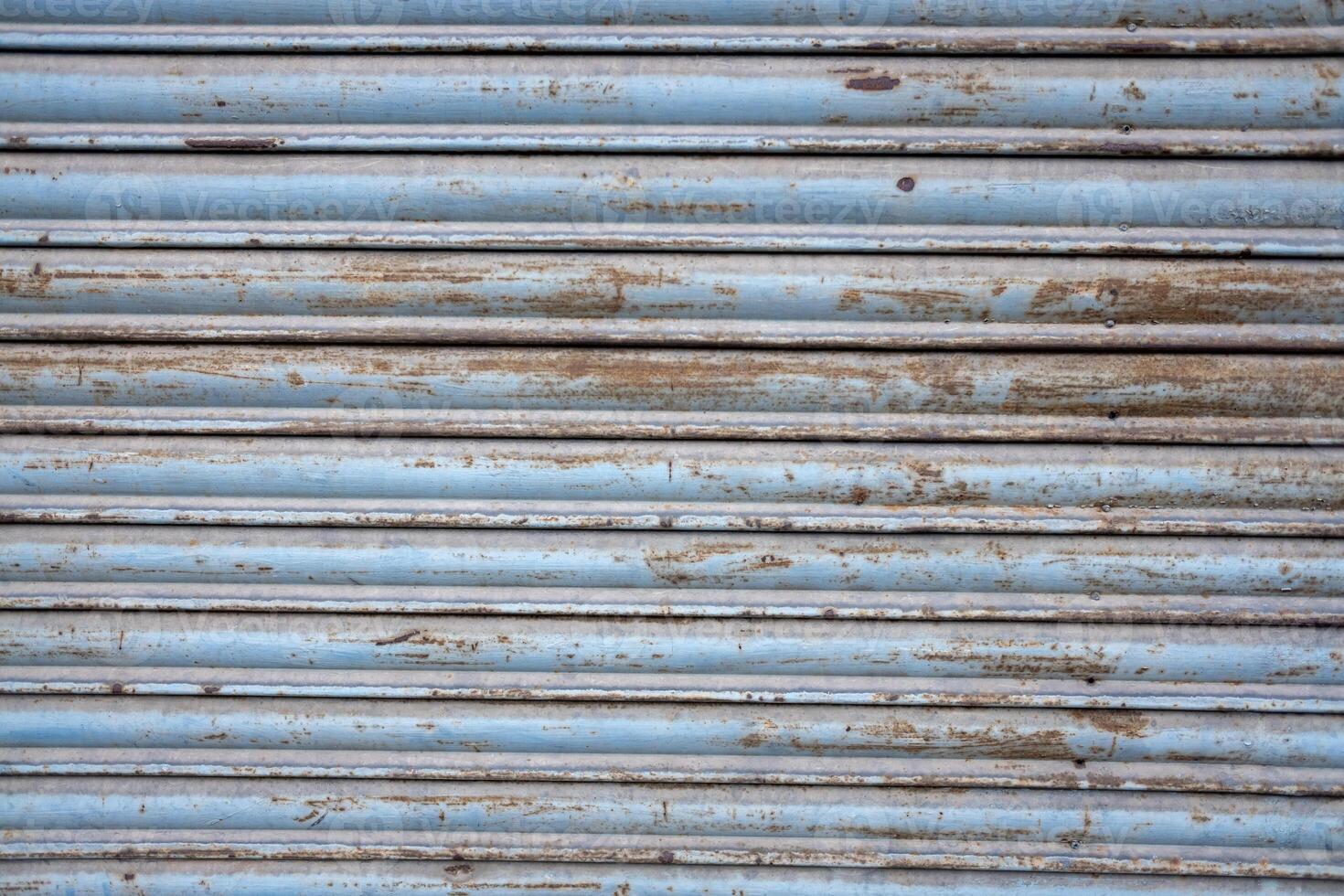 old metal shutter, rusted and weathered paint. Textured background photo