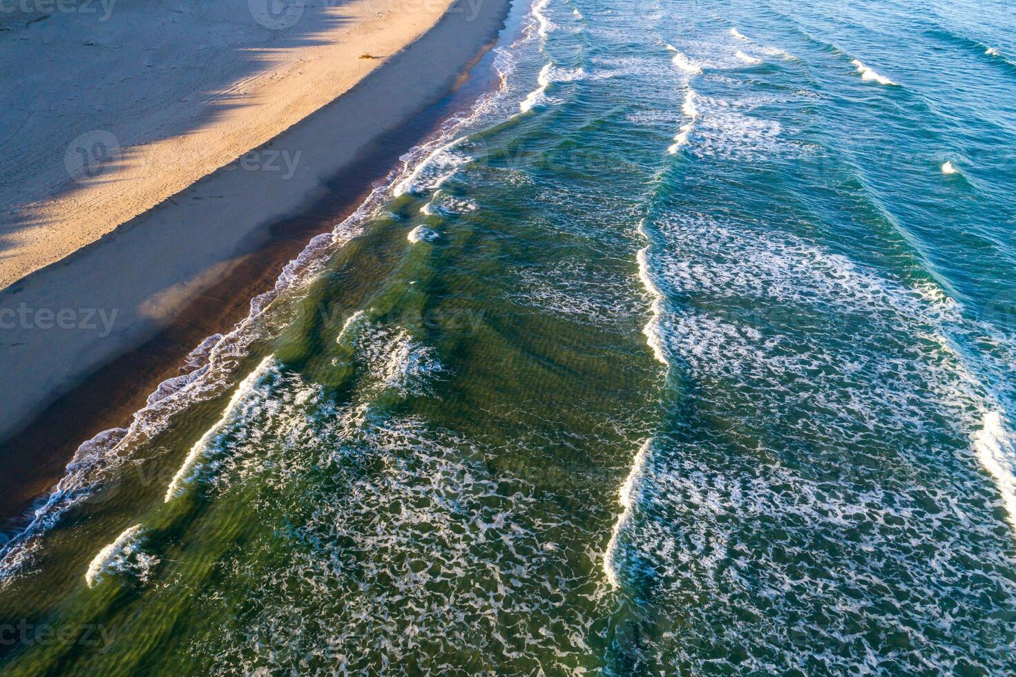 view of the shore of a beach at sunrise, aerial photography with drone at sunset. Summer concept background photo
