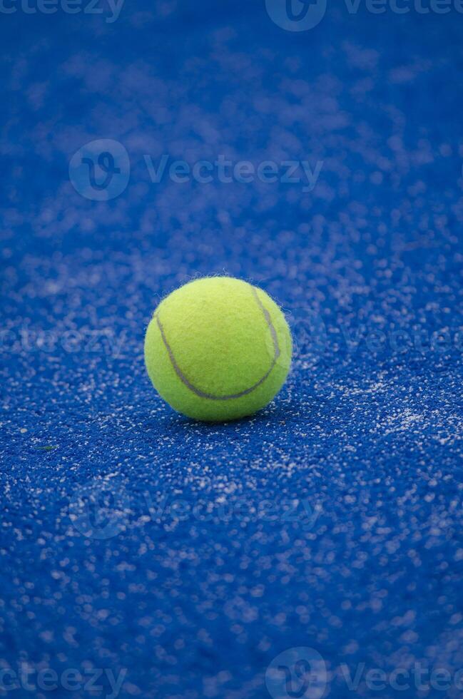 selective focus, one ball on a blue artificial grass paddle tennis court photo
