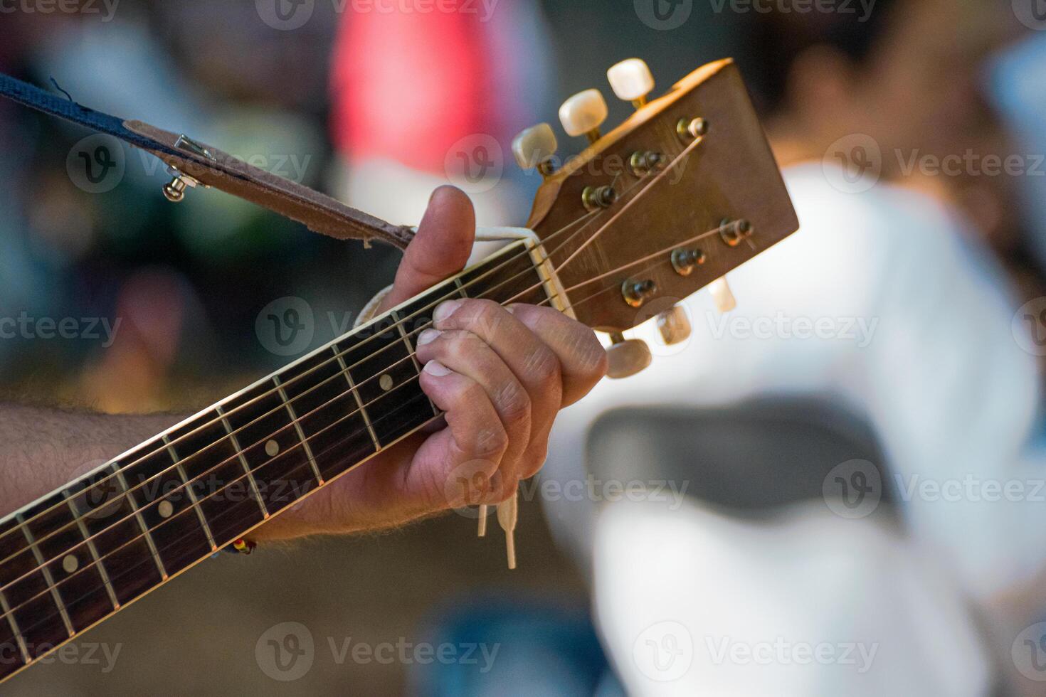 hand gripping spanish guitar neck, creating music photo