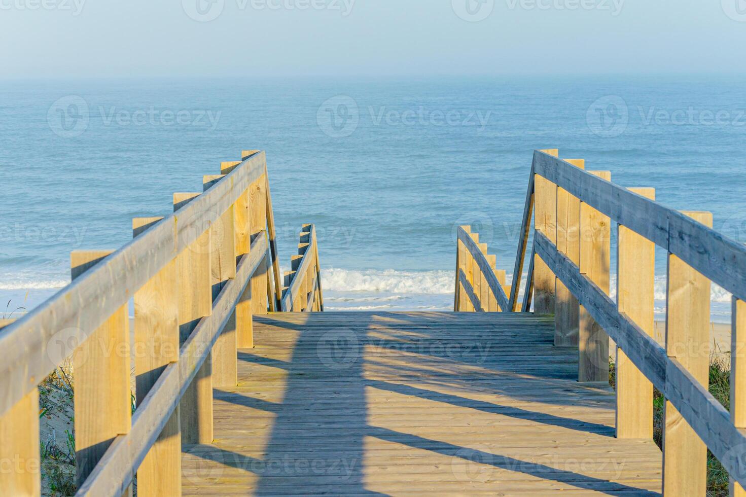 wooden walkway on a beach at dawn, summer background concept photo