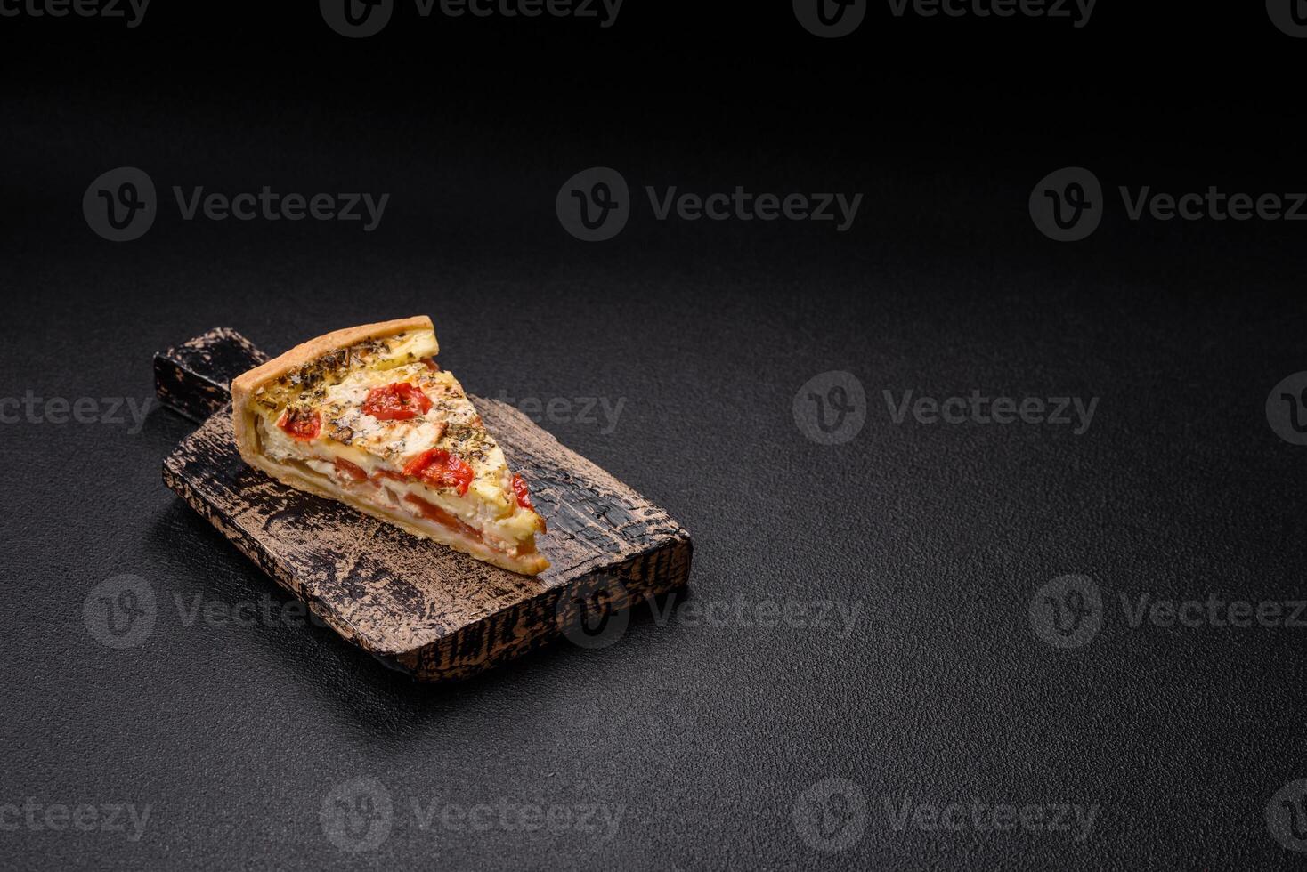 Delicious crispy quiche cut into slices with cheese, broccoli, tomatoes photo
