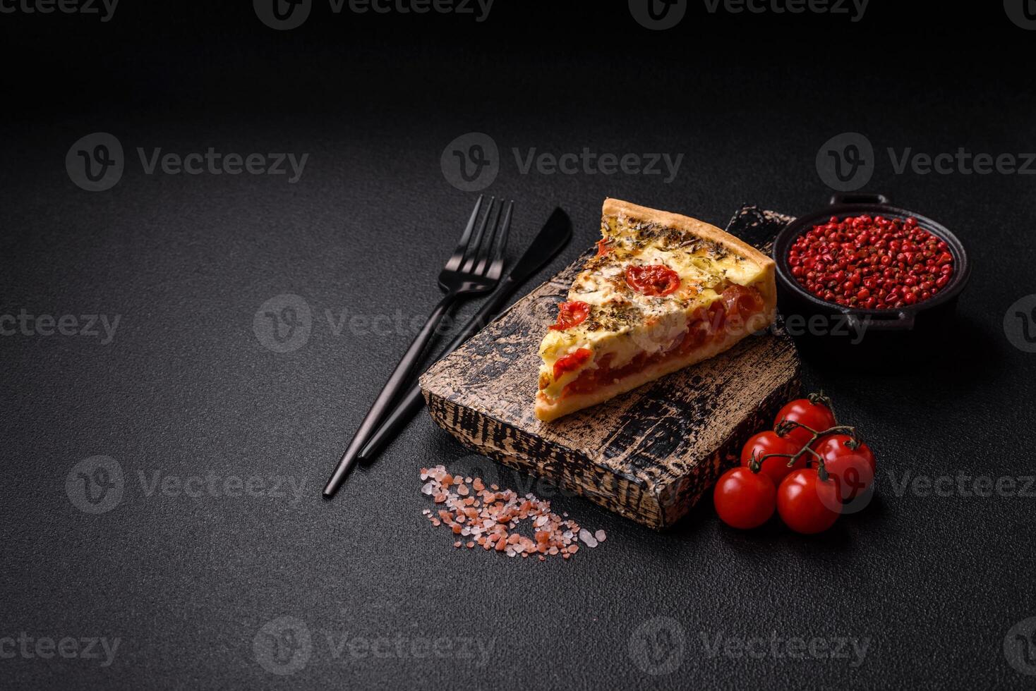 Delicious crispy quiche cut into slices with cheese, broccoli, tomatoes photo