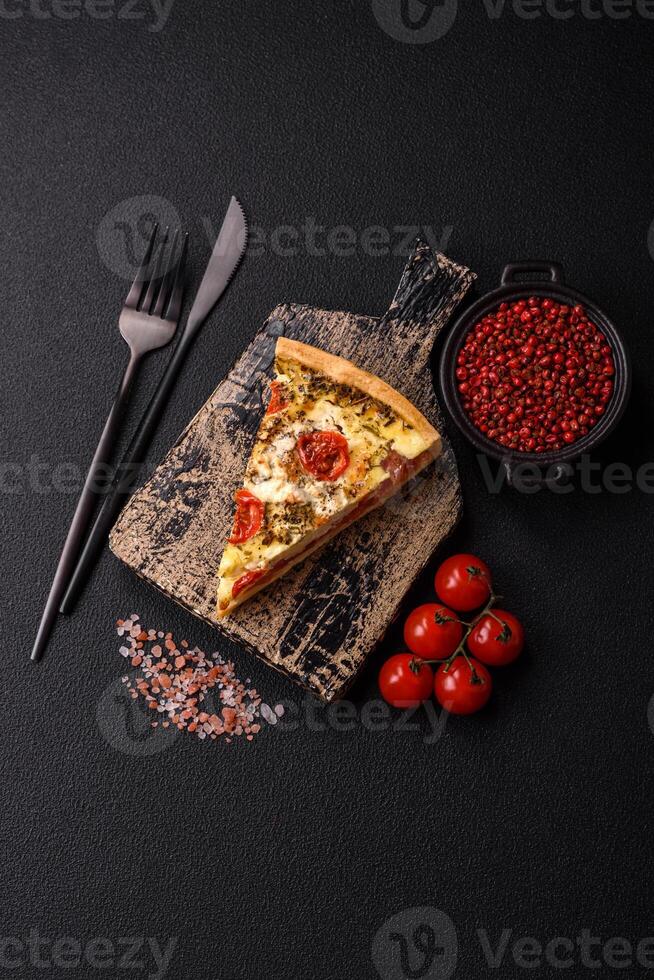 Delicious crispy quiche cut into slices with cheese, broccoli, tomatoes photo