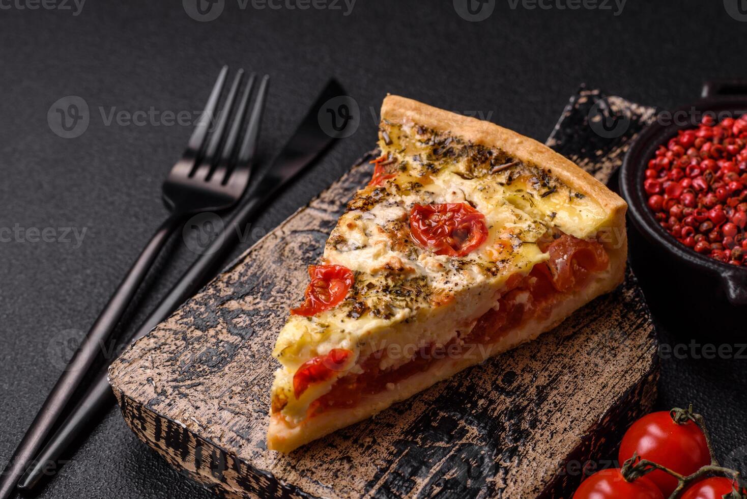 Delicious crispy quiche cut into slices with cheese, broccoli, tomatoes photo