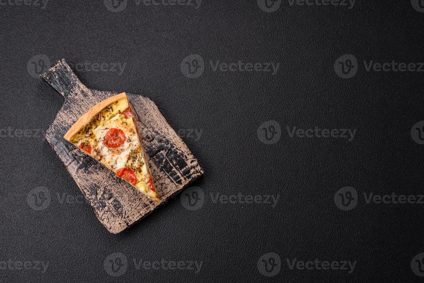 Delicious crispy quiche cut into slices with cheese, broccoli, tomatoes photo
