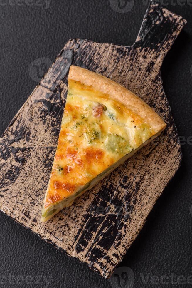 Delicious quiche with broccoli, cheese, chicken, spices and herbs photo