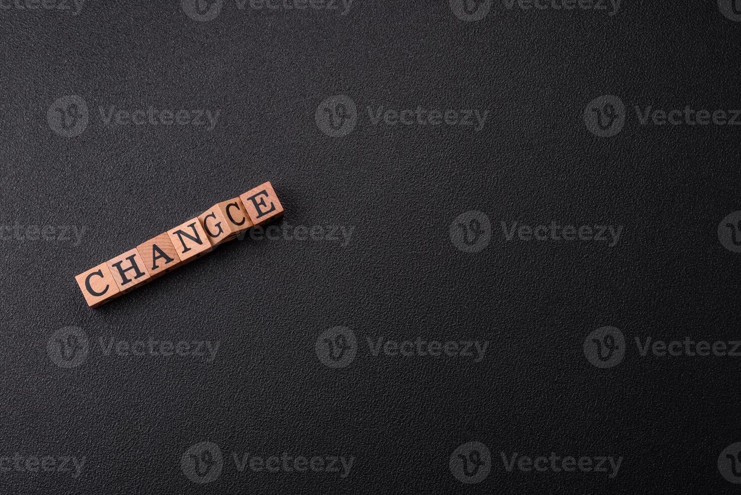 The inscription chance or change with wooden cubes on a dark concrete background photo