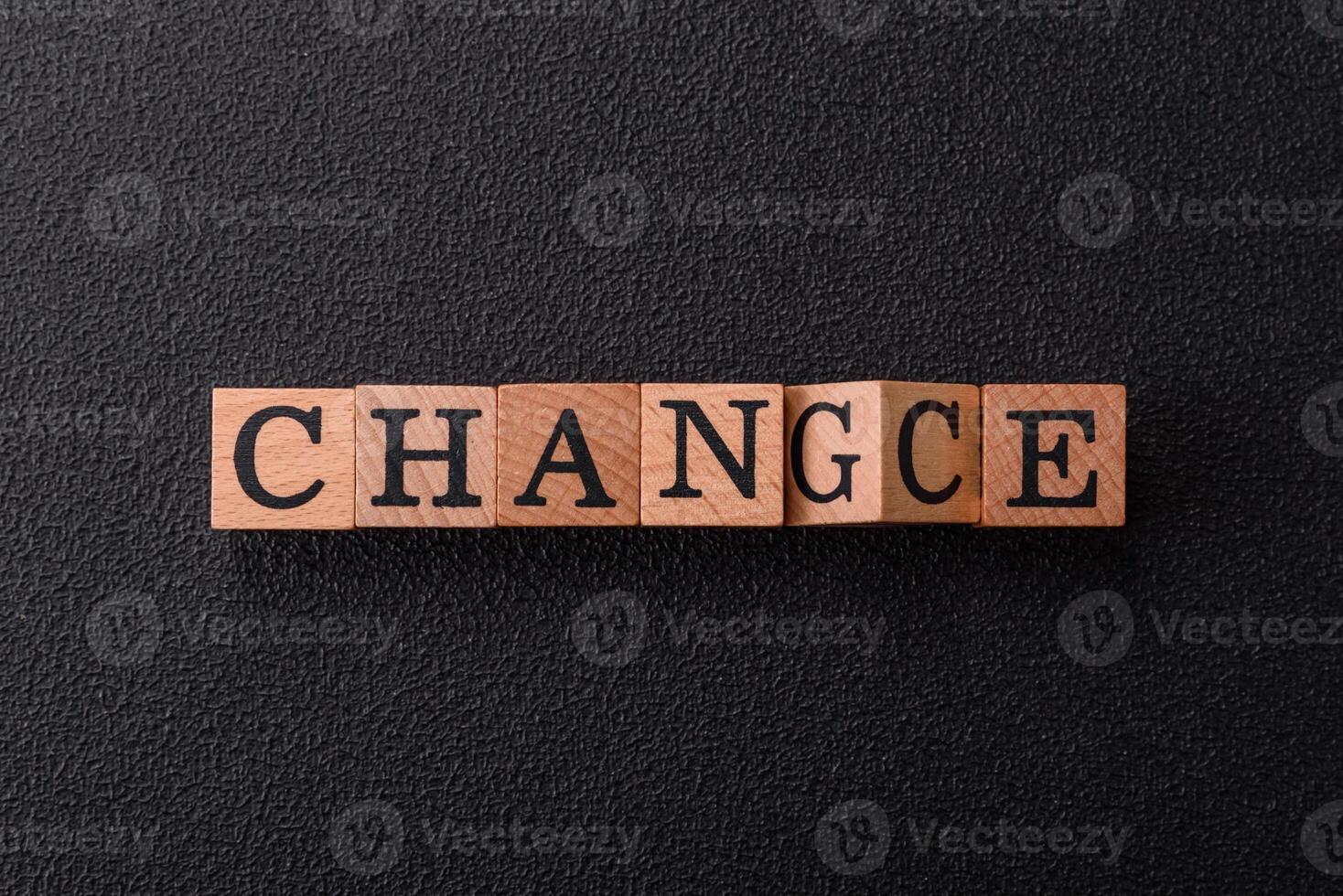 The inscription chance or change with wooden cubes on a dark concrete background photo