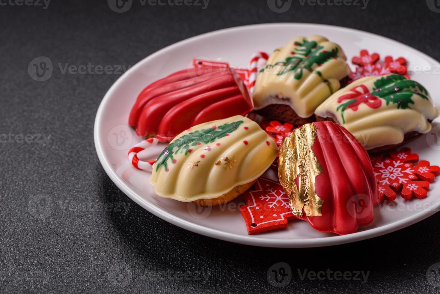 Sweet Madeleines desserts covered with chocolate in Christmas colors photo