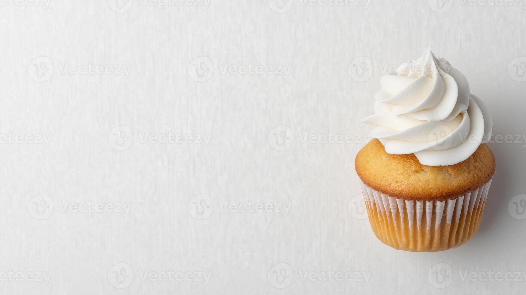 Delicious vanilla cupcake with creamy frosting on a plain background photo