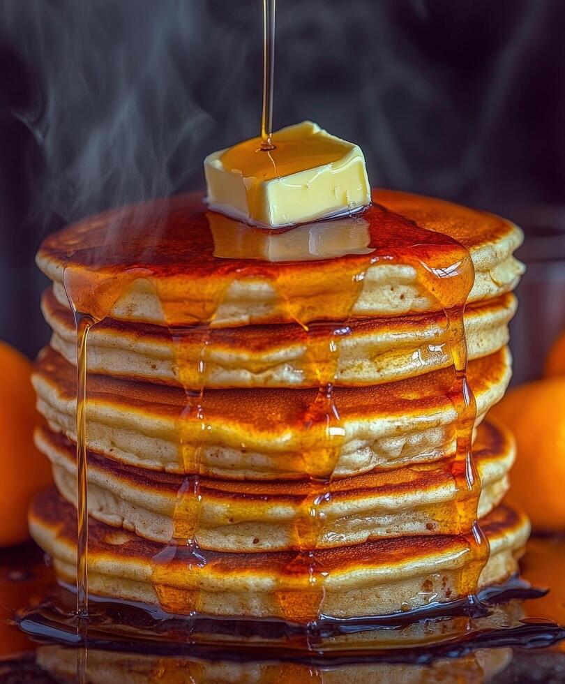 Stack of warm pancakes with syrup and butter on top photo