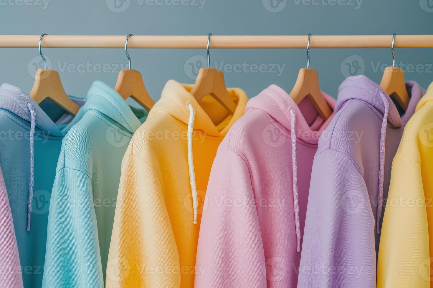 Colorful hoodies neatly arranged on a display rack photo