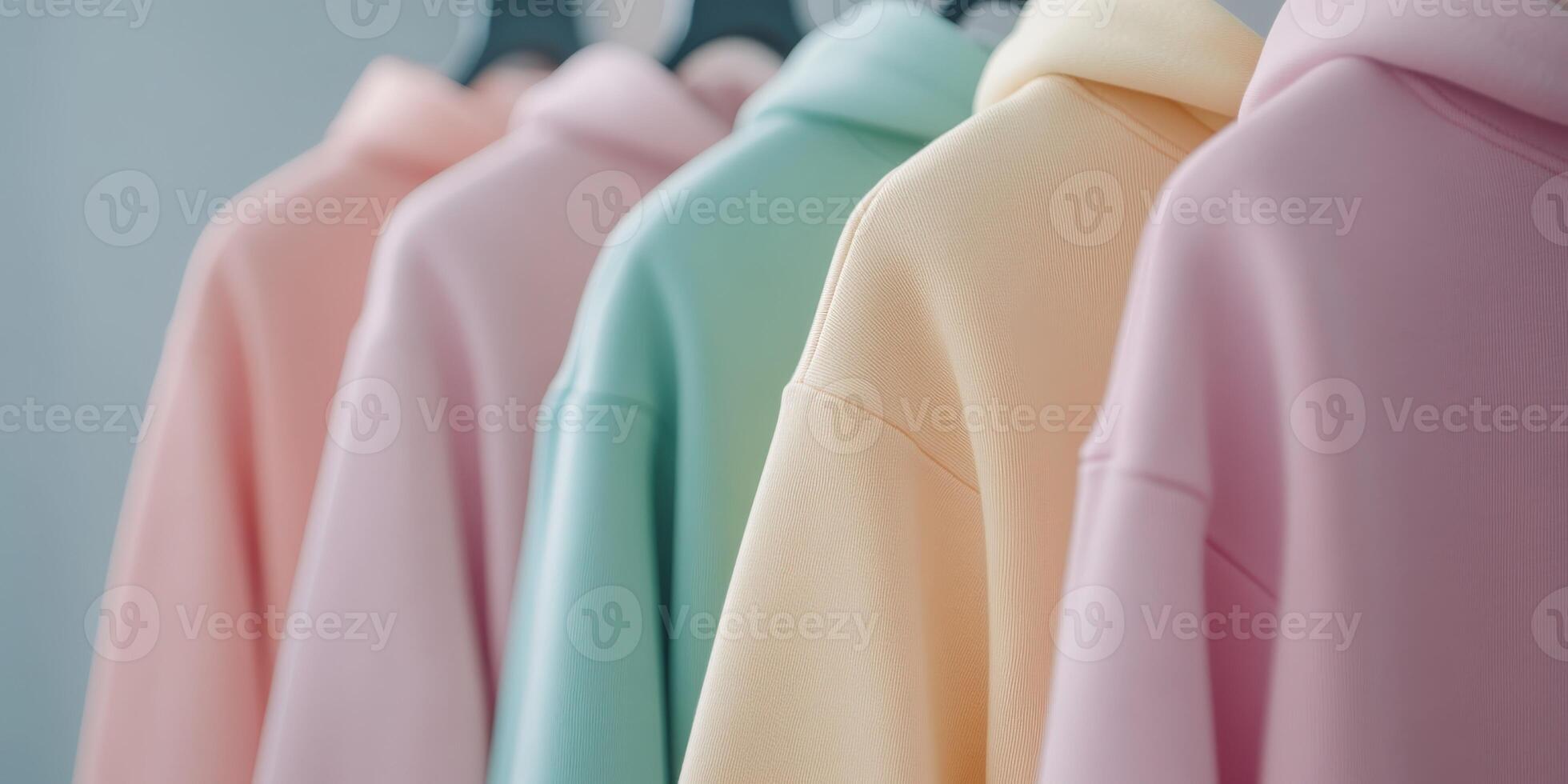 Soft pastel hoodies hanging in a stylish showcase photo