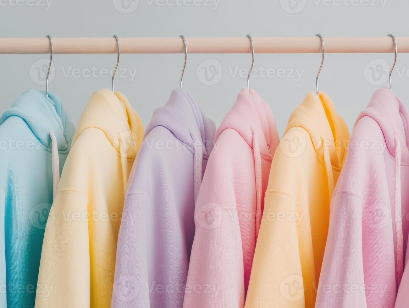 Colorful hoodies hanging on a rack in a stylish setting photo