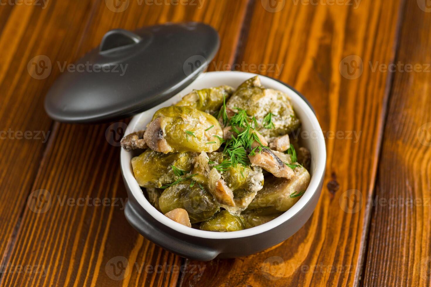 Brussel sprouts stewed in sour cream sauce with mushrooms and spices photo