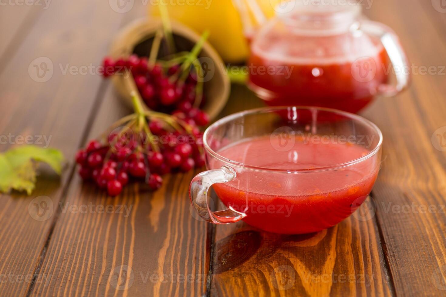 tea from ripe red viburnum on a wooden table photo
