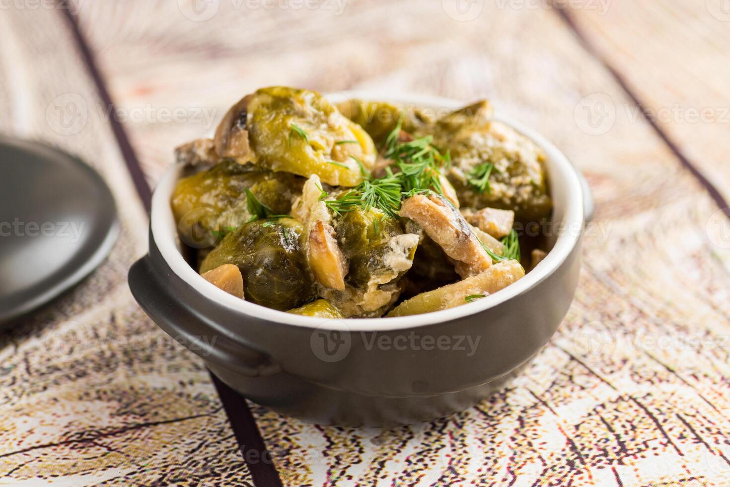 Brussel sprouts stewed in sour cream sauce with mushrooms and spices photo