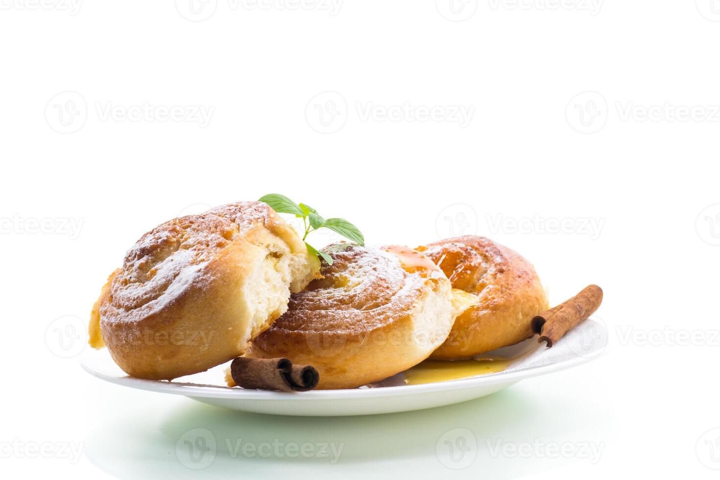 Baked goods. Sweet buns with cottage cheese filling and honey in a plate isolated on a white background photo