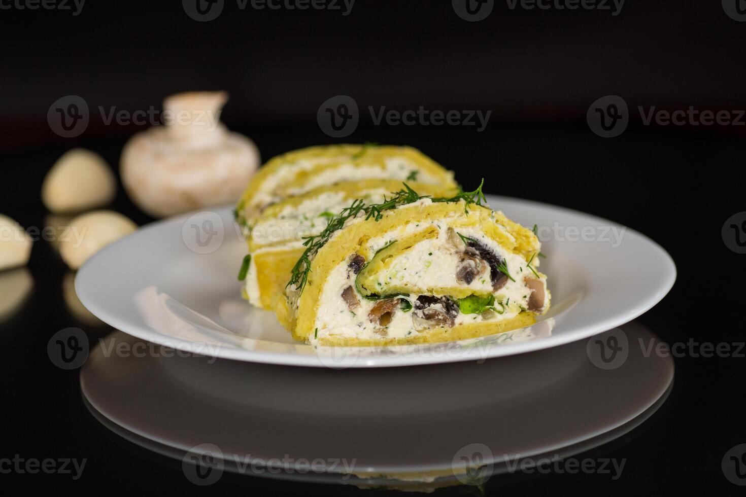 baked potato roll with cottage cheese filling with garlic and mushrooms, isolated on black background photo
