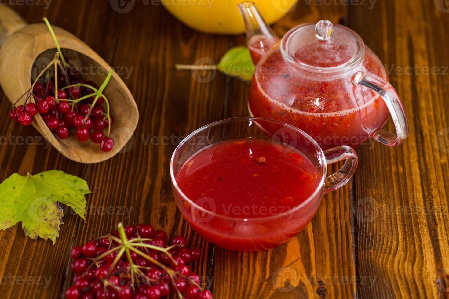 tea from ripe red viburnum on a wooden table . photo
