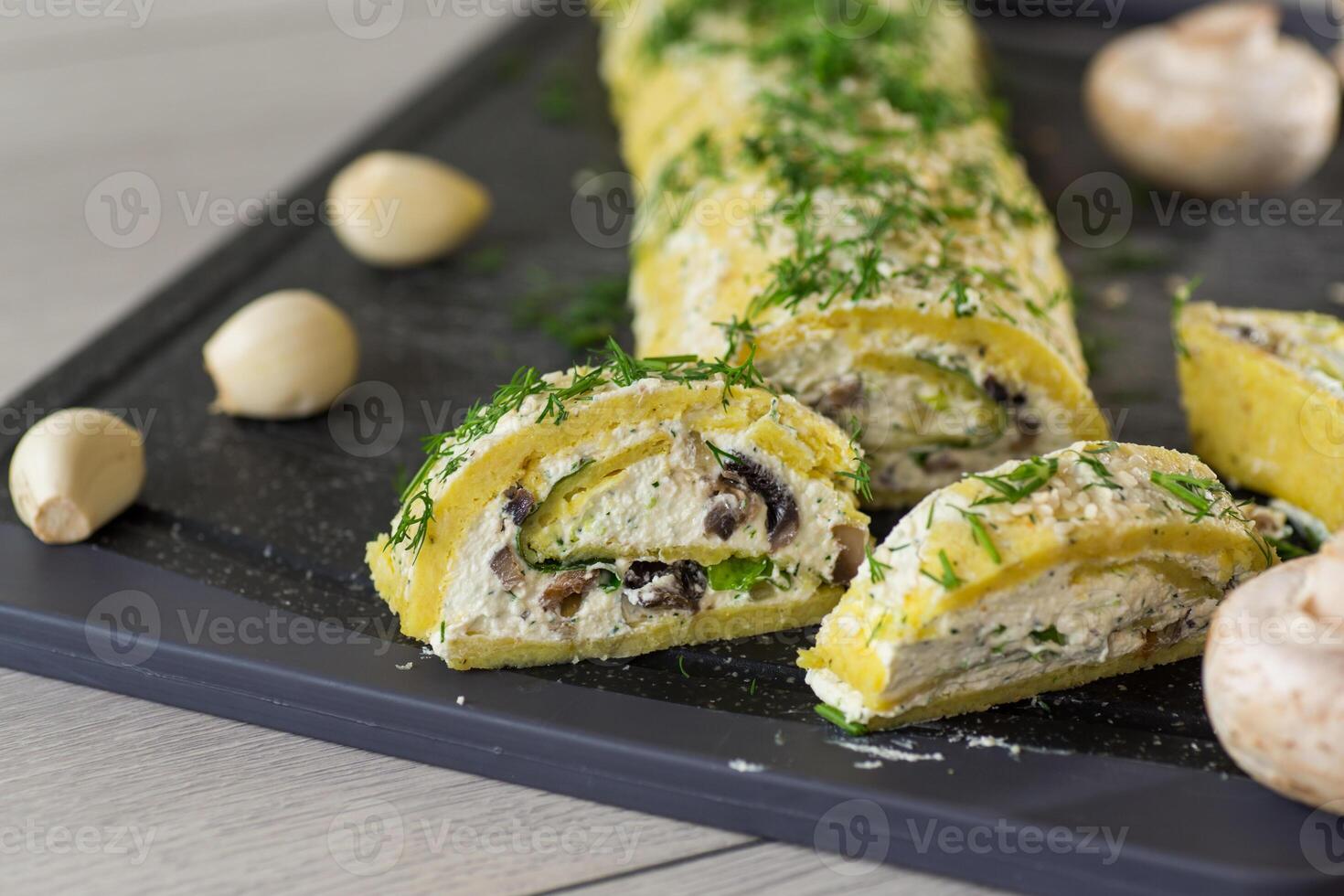 baked potato roll with cottage cheese filling with garlic and mushrooms, on a light wooden table photo