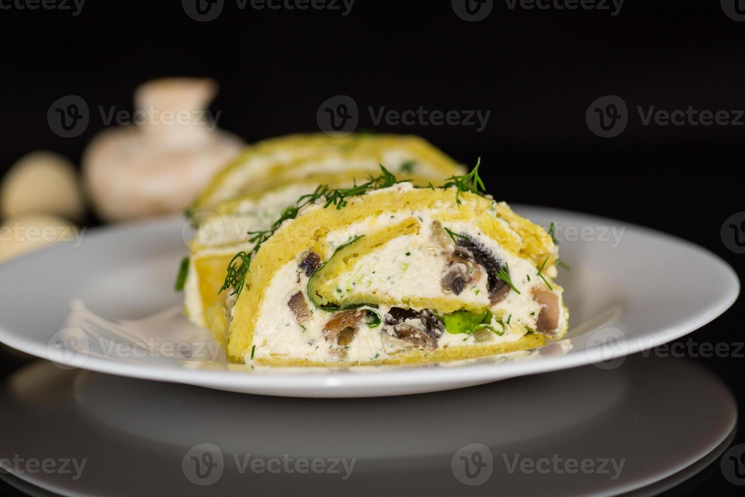 baked potato roll with cottage cheese filling with garlic and mushrooms, isolated on black background photo
