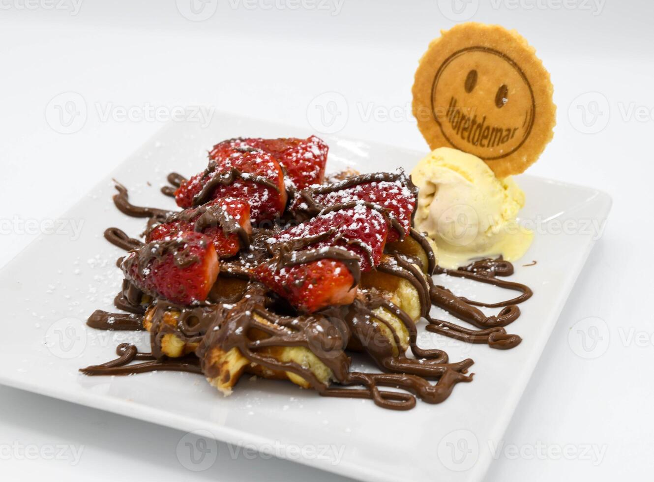 Waffles with chocolate and strawberries on a white plate close-up photo