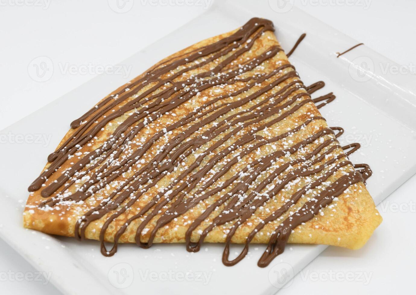 Pancakes with chocolate on a white background, close-up photo