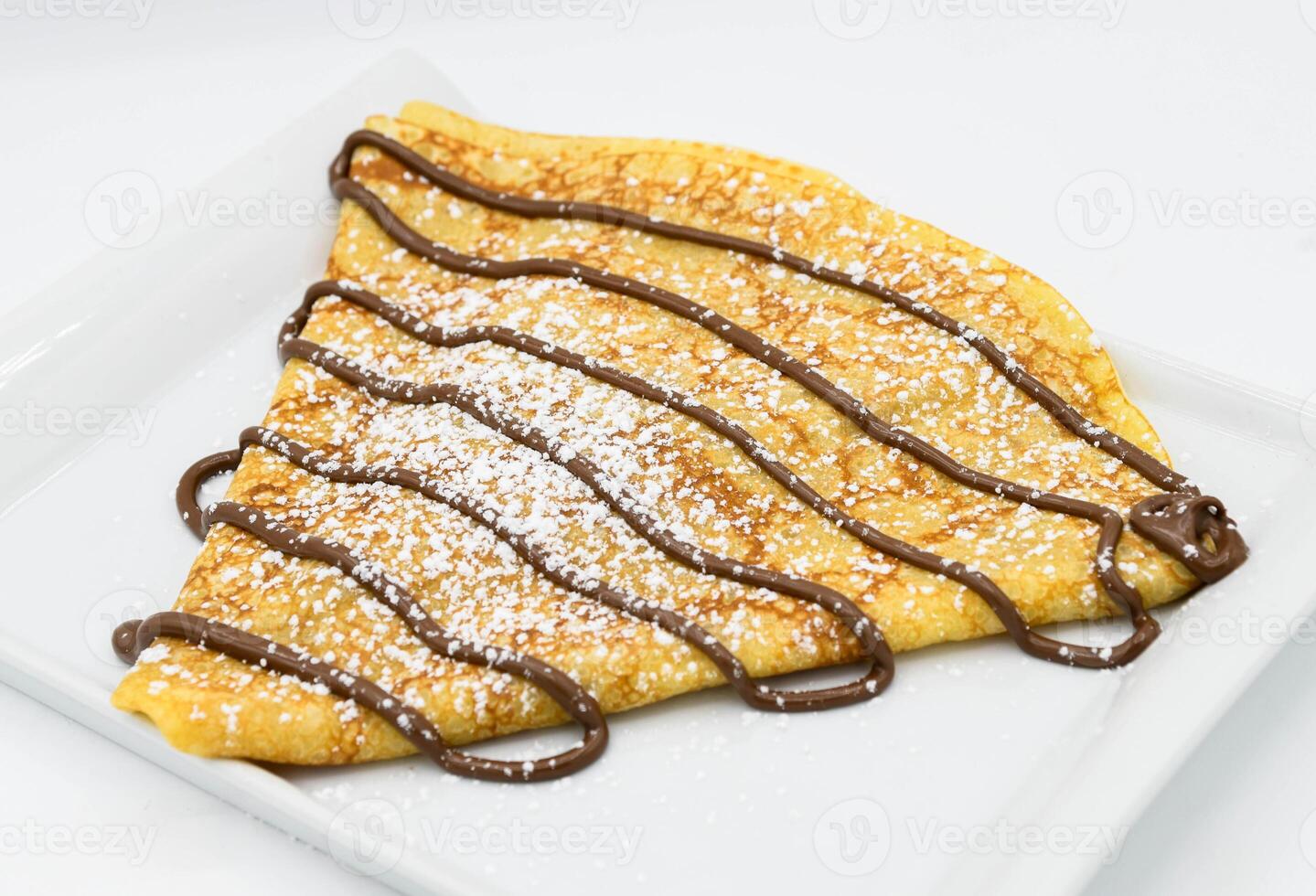 Pancakes with chocolate on a white background, close-up photo