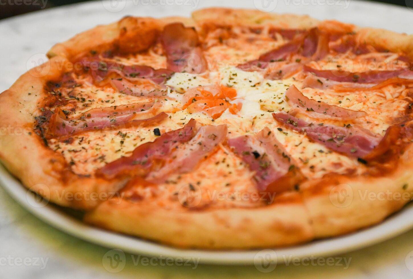 Italian pizza with bacon and fried egg photo