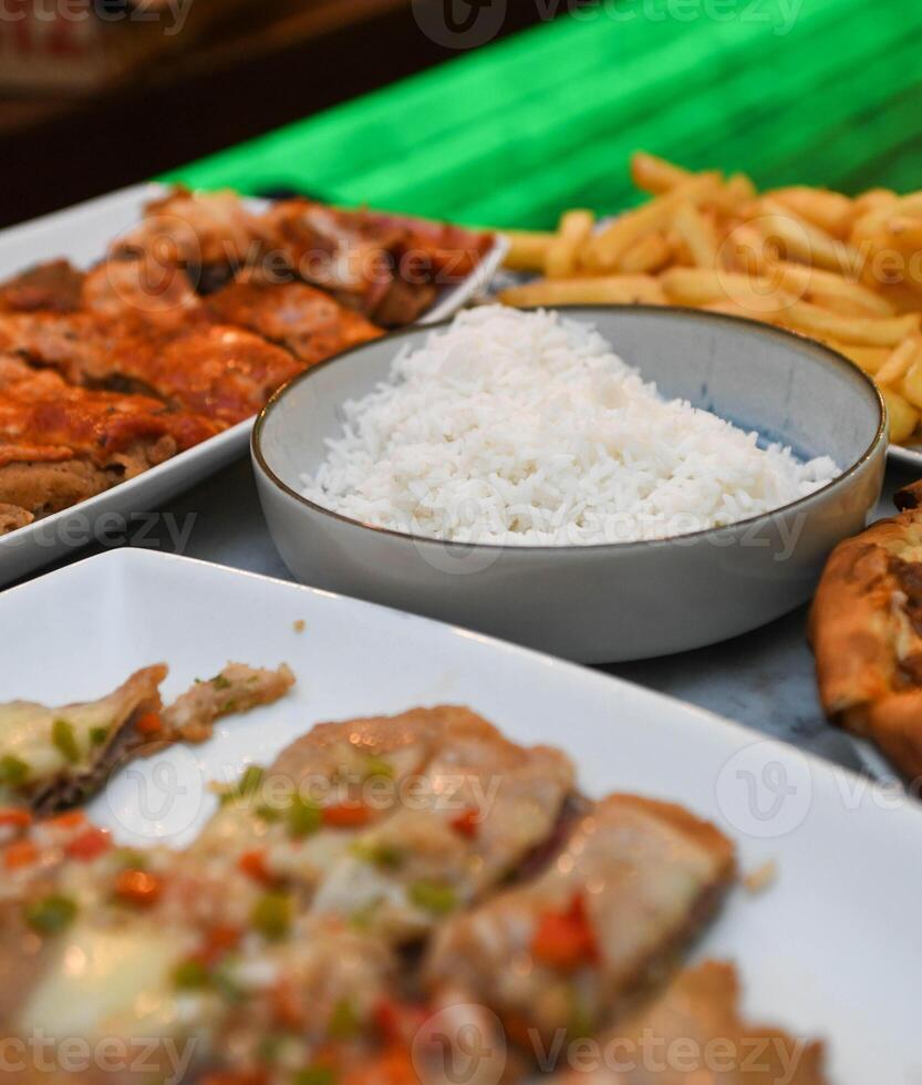 Snack dinner with pizzas and Argentine milanesa. photo