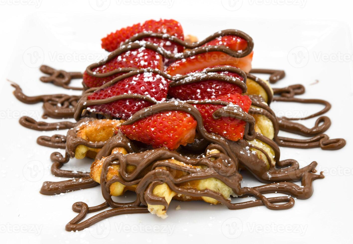 Waffles with chocolate and strawberries on a white plate close-up photo