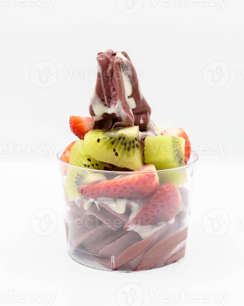 Yogurt and acai ice cream with chopped fruit pieces photo