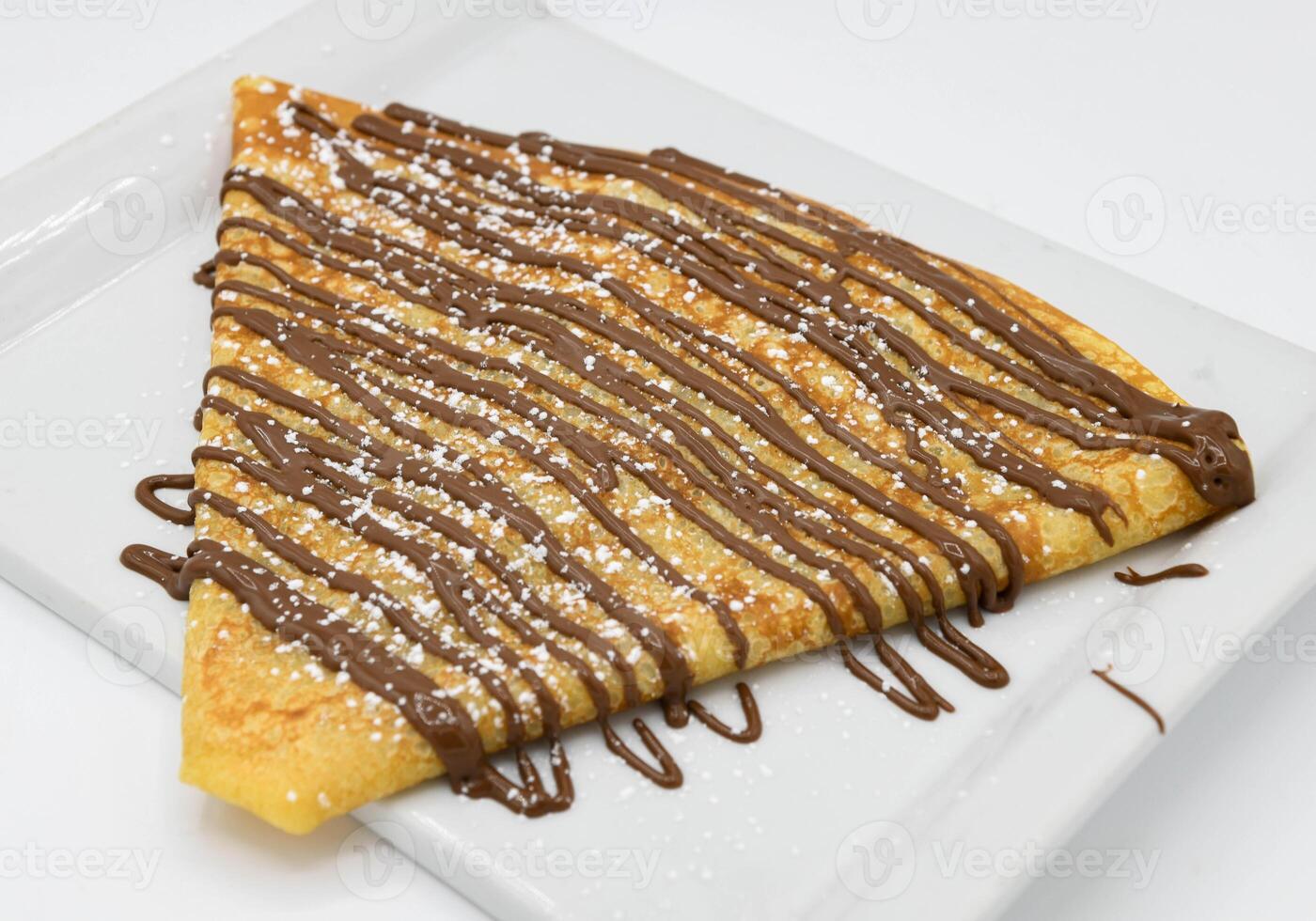 Pancakes with chocolate on a white background, close-up photo