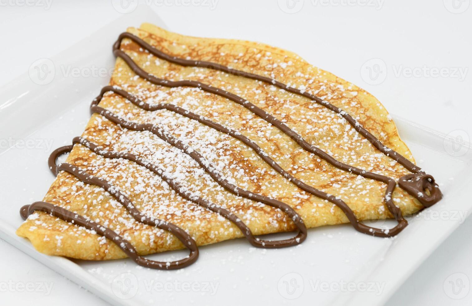 Pancakes with chocolate on a white background, close-up photo