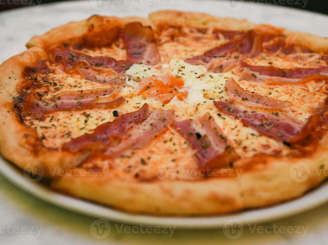 Italian pizza with bacon and fried egg photo