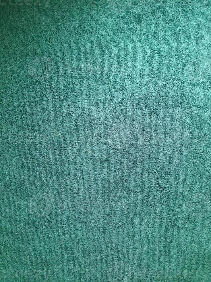 close-up of a teal fabric with a short, fuzzy pile. The fabric appears soft and textured, with a subtle sheen. photo
