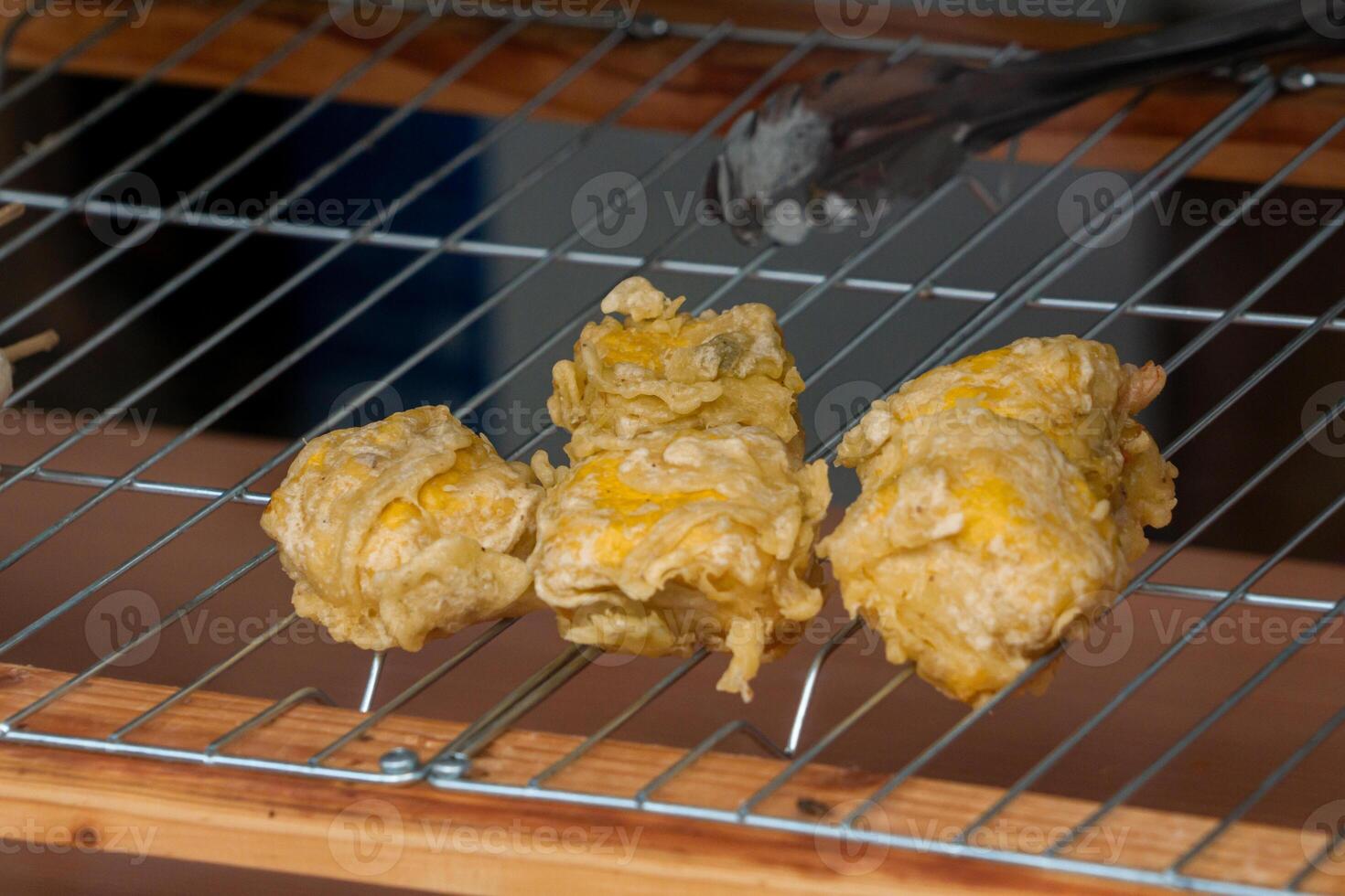 Gehu, a fried tofu and bean sprout snack, served at an angkringan. This crispy and savory Indonesian street food is a popular choice among locals and tourists photo
