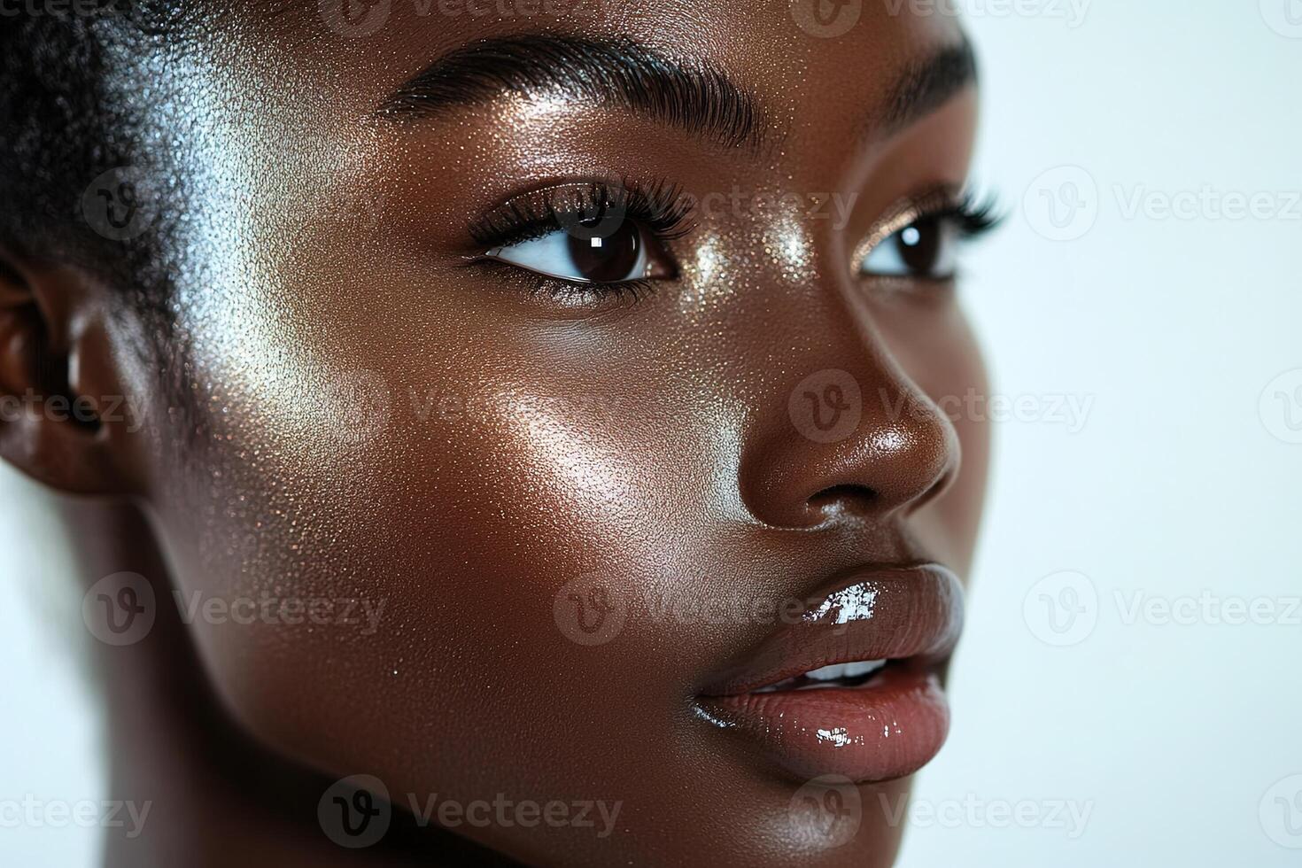 Close-Up of Glossy Makeup Look Featuring Golden-Bronze Highlighter and Natural Shine photo