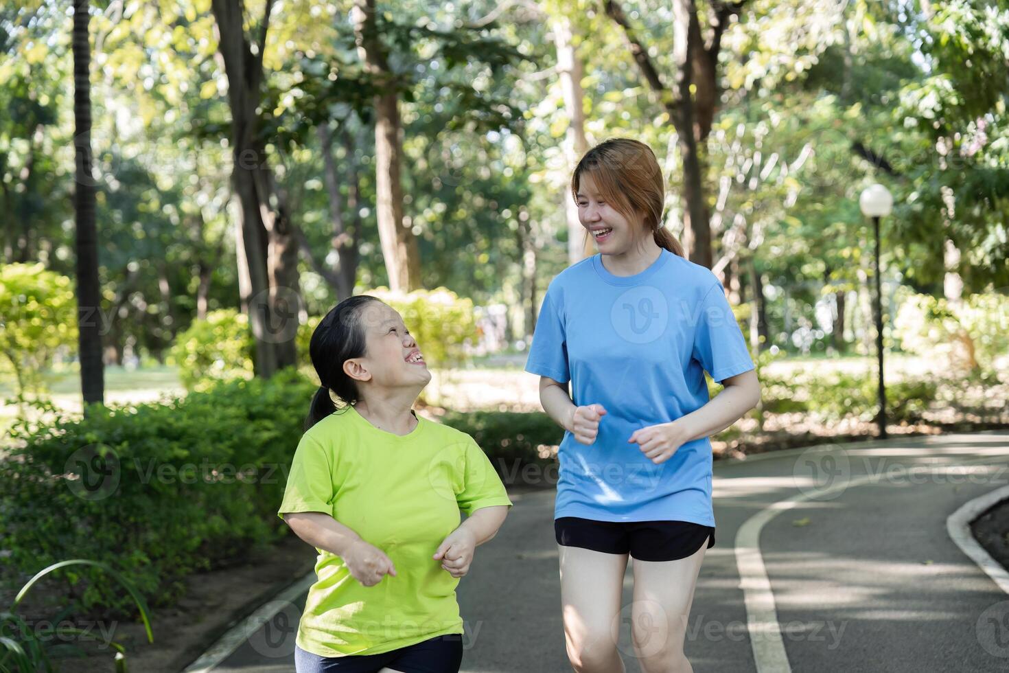 Young Woman with Physical Differences Exercising with Friend in Park, Promoting Inclusivity and Friendship through Fitness photo