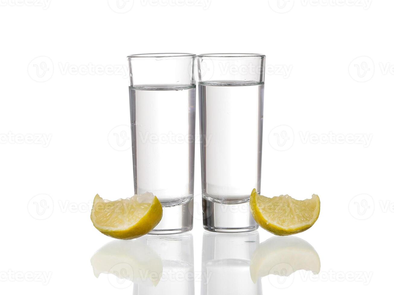 Three tequila shots with lime isolated on white background photo