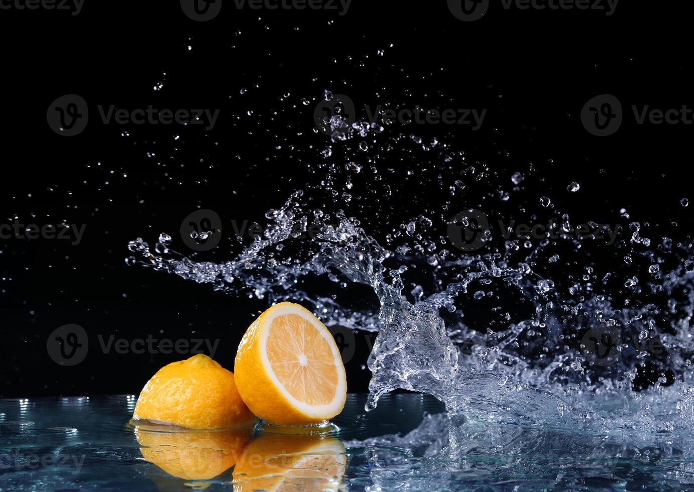 Sliced lemon in the water on black background photo