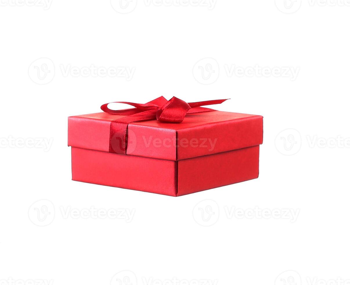 Red gift box with white ribbon isolated on red background. Clipping path included. photo