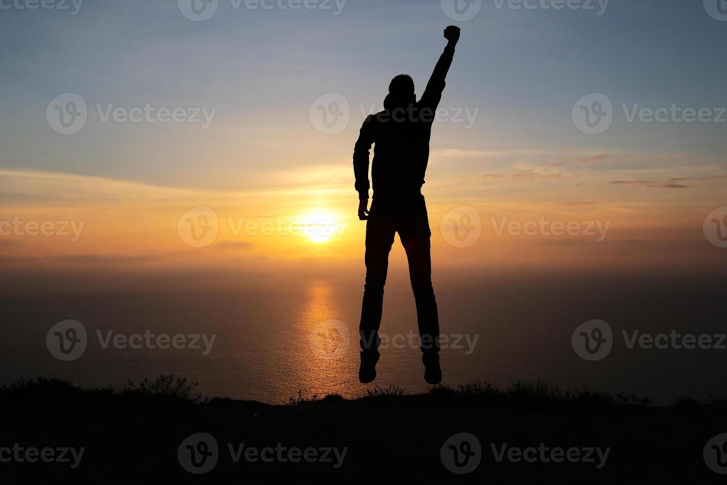 Silhouette of running man against the colorful sky. Silhouette of running man on sunset fiery background photo