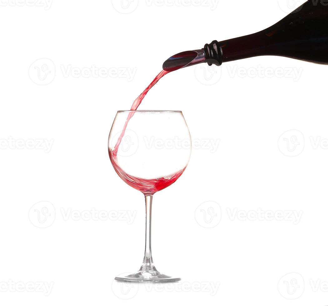 red wine pouring into wine glass isolated photo