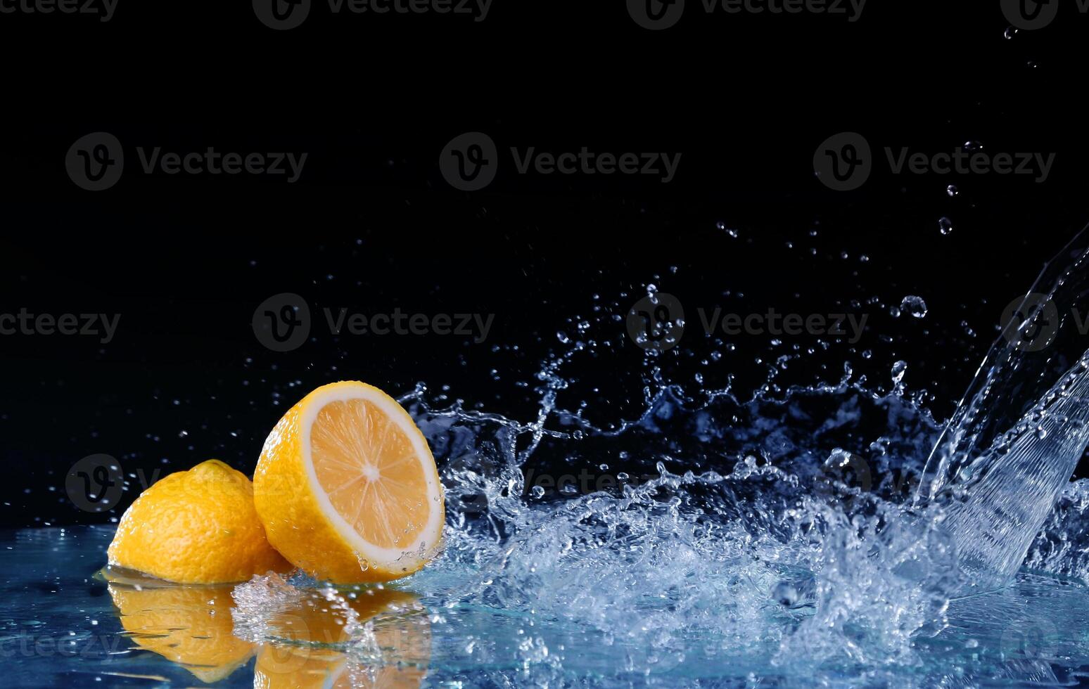 Sliced lemon in the water on black background photo