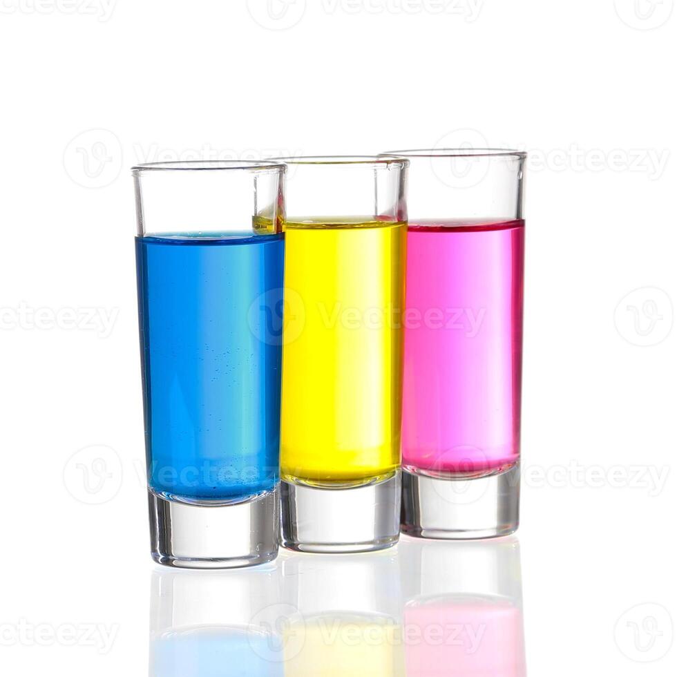 Shots - Three colourful shot drinks on a white background with reflections photo